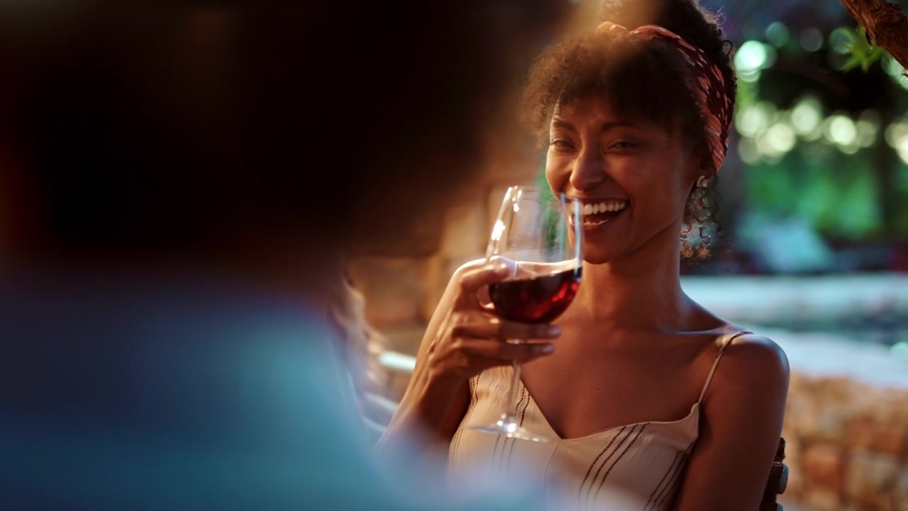 Happy Woman Laughing and Drinking Red Wine at Outdoor Dinner