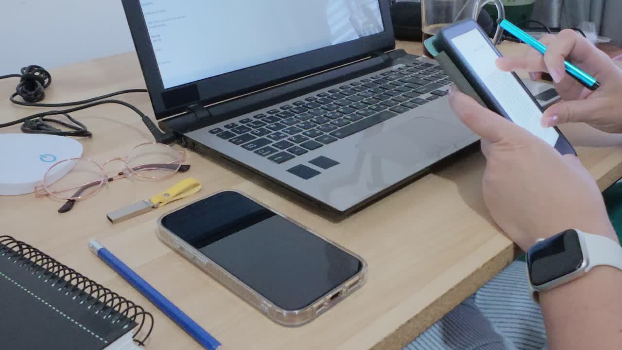 Hands using a stylus on a tablet, potentially for e-signatures or digital markups on documents,