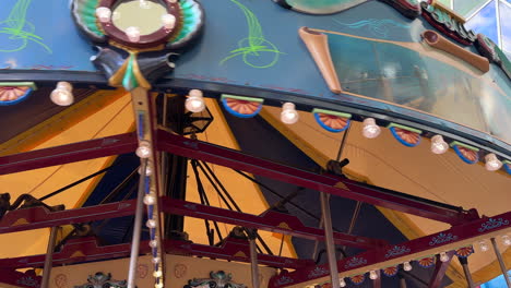 view looking up, carousel carnival ride spinning, amusement park