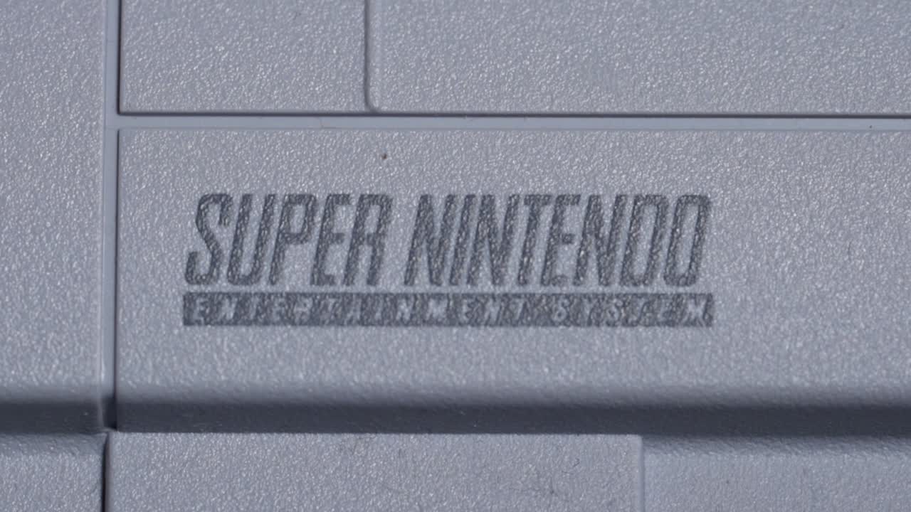 Super Nintendo Classic Video Game Console, Logo Macro Shot.