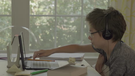 Young-boy-on-tablet-at-home-in-virtual-learning-class