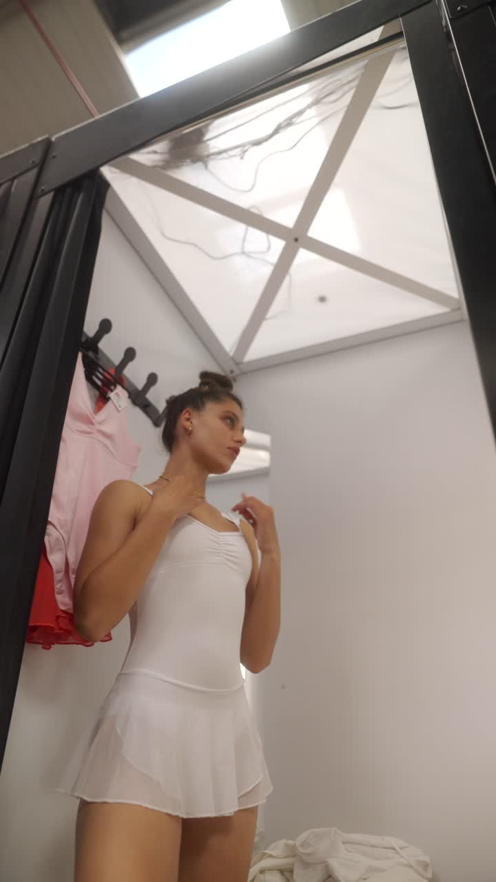 Woman trying on a ballet leotard in a dressing room