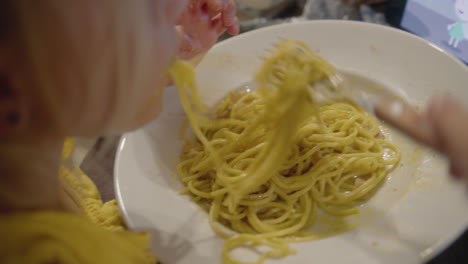 little girl having spaghetti for dinner