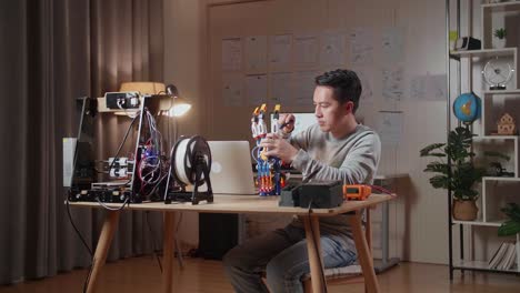 person working on a 3d printed robotic hand prototype