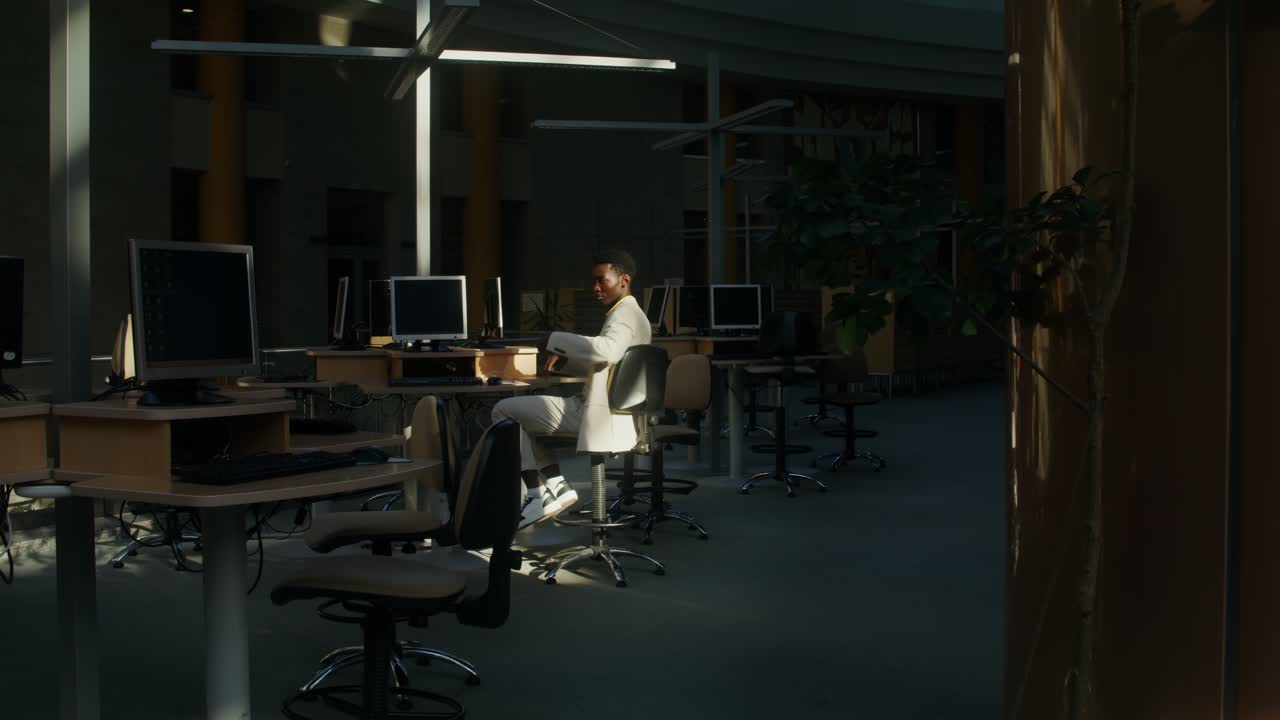 Man sitting in an office with computers