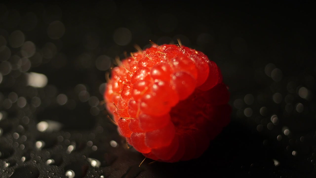50p extreme close up shot of a raspberry rotating to reveal its texture