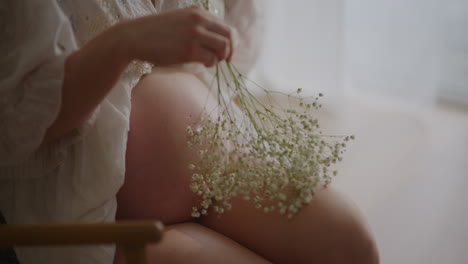 pregnant woman with baby's breath on stomach