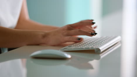 closeup journalist hands typing wireless keyboard creating article at office.