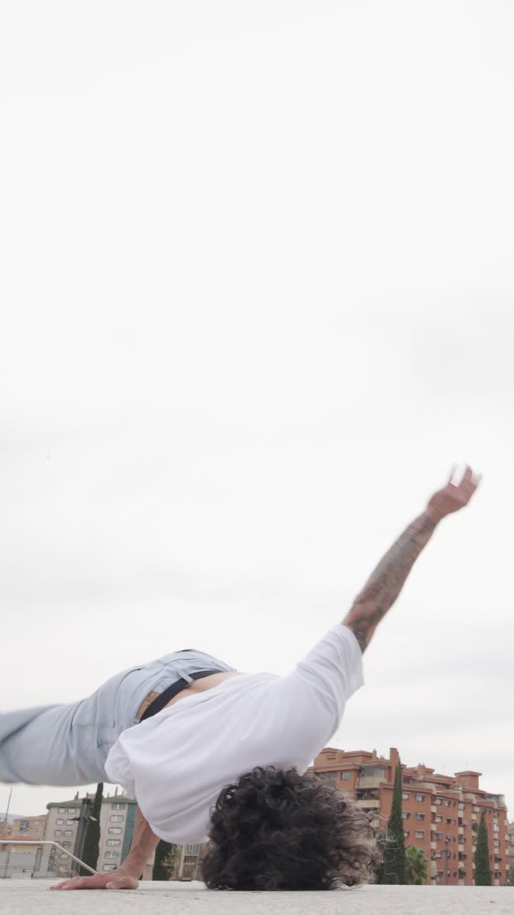 Breakdancer performing acrobatics on rooftop