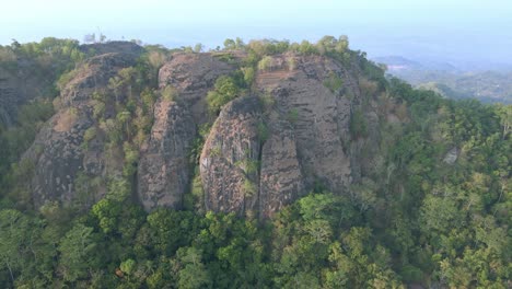 aerial birds eye view flying over pre historic volcano in indonesia