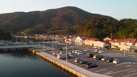 aerial upwards over small japanese fishing village at sunrise