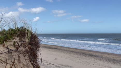 sand dunes with beach and blue sky