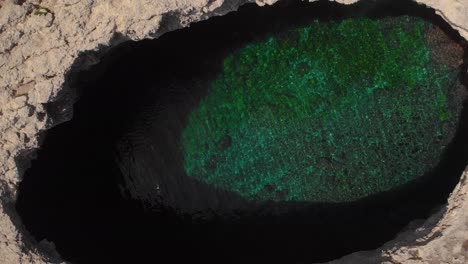 AERIAL:-Flying-out-of-famous-Cave-called-Blow-Hole-in-Mellieha,-Malta