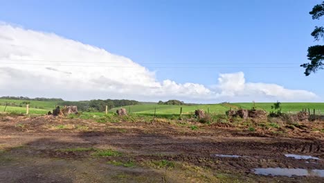 tractor moving through a rural farm landscape