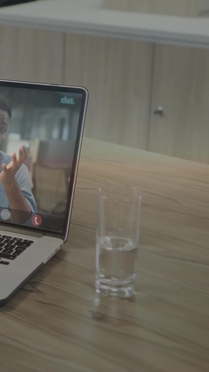 Vertical video: Man gesturing on laptop sparking UI sliding right casting code on glass for IT demo