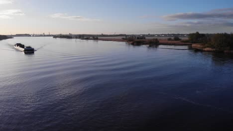 Barco-De-Carga-En-El-Río-Oude-Maas-Durante-La-Puesta-De-Sol-En-Holanda-Del-Sur,-Países-Bajos