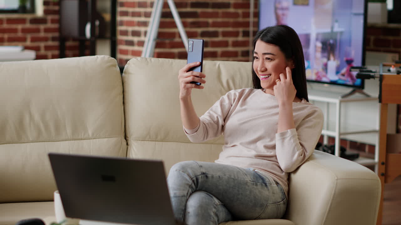 Woman taking a selfie on the couch