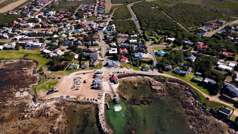 Aerial-tilt-down-over-harbour-as-shark-cage-diving-boat-is-pulled-up-slipway