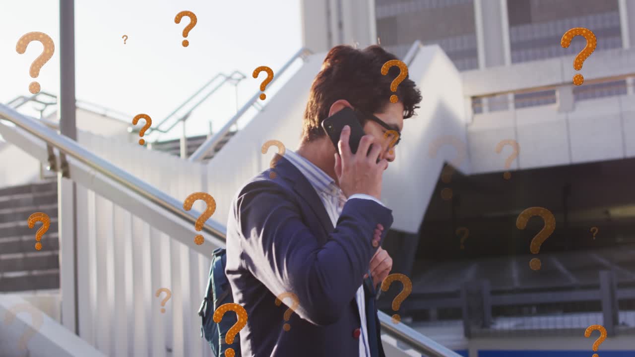 Animation of question marks over asian businessman talking on smartphone