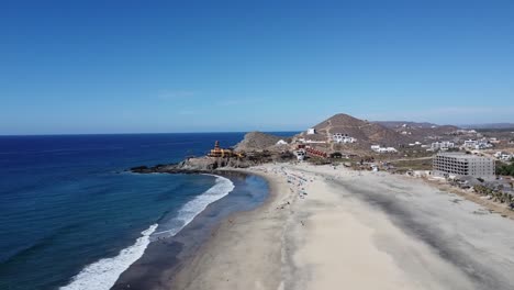 aerial view of beautiful beach of cerritos beach in baja california sur during a vacation trip through mexico with a view of the blue sea, hotel buildings and dry landscape on a sunny cloudless day