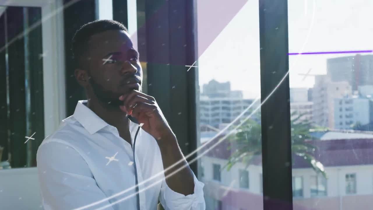 Animation of lines and circles over thoughtful african american man looking through window