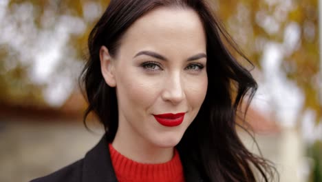 woman with vivid makeup smiling playfully