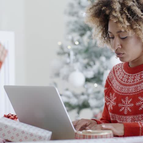 Trendy-young-woman-working-on-a-laptop