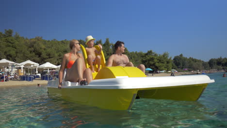 family with child enjoying pedal boat ride