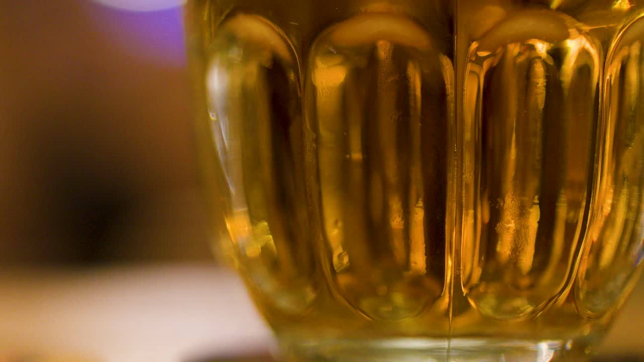 Closeup of foamy lager beer in glass mug at a Czech brewpub, warm atmosphere