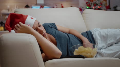 close up of adult sleeping on couch with bowl of chips