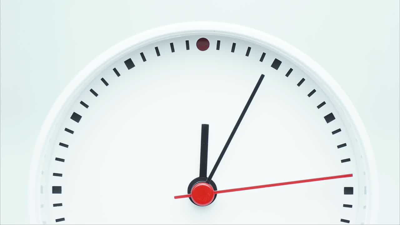 Time lapse white  clock tells the time 12 o'clock and 15 minute.