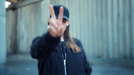 woman showing v sign on the street