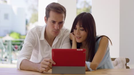 smiling couple using a tablet computer together