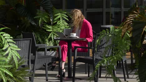 Joven-Y-Elegante-Mujer-De-Negocios-Se-Sienta-Elegantemente-Fuera-De-La-Oficina-Y-Trabaja-Con-Su-Computadora-Portátil