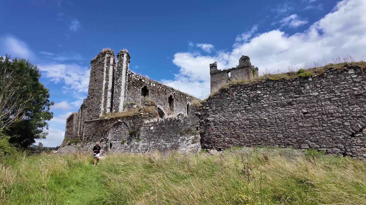 Ireland epic Locations Wexford Dunbrody Abbey woman wandering and admiring the impressive ruins of this important monastic site on a summer day