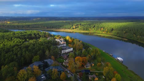 banks of village of birstonas at memel river during autumn with spa and sanatorium