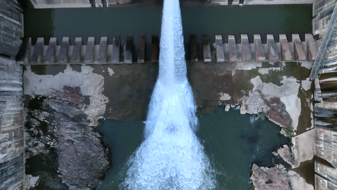 Overhead top view of Dam spillway, reservoir at severe low water levels, aerial