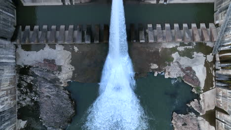 overhead top view of dam spillway, reservoir at severe low water levels, aerial