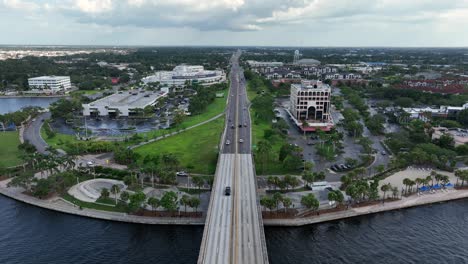 cars on street and bridge in bradenton downtown during cloudy day. florida, usa. aerial birds eye shot. manatee memorial hospital in background. panorama view