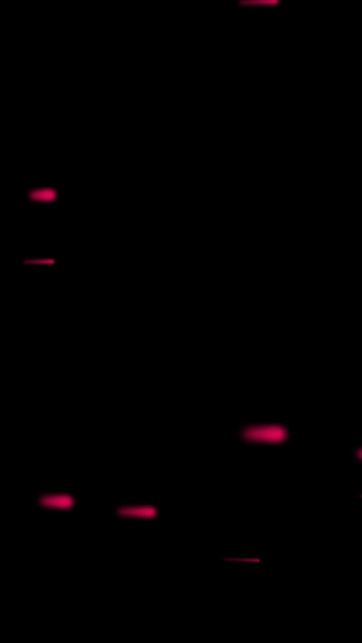 Animation of glowing red light trails moving over black background