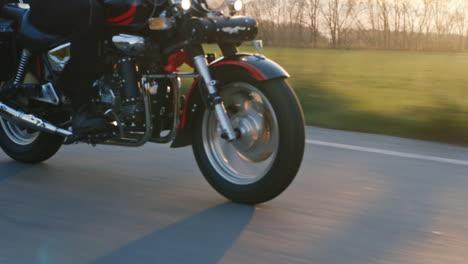 motorcycle wheels which quickly goes on the road the sun shines and gives a nice glare hd video