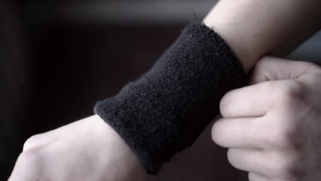 person putting on a black wristband