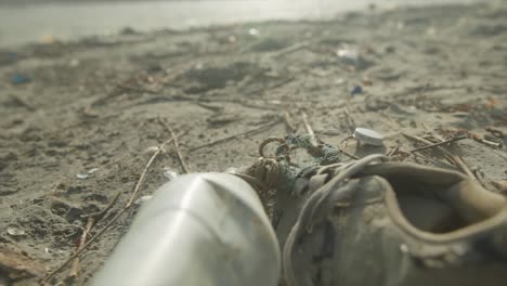 garbage washed away by the river are lying on the beach - water pollution idea footage