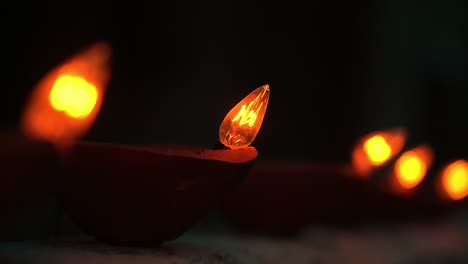 close up led lamps, foreground with om symbol on top and another in background bokeh defocused blurred at indian hindu festival of lights- diwali- decorative item celebration preparation