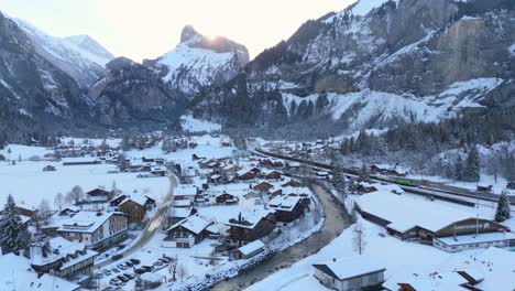 picturesque town in mountain valley below the alps in winter snow