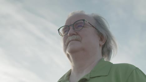 Close-up-of-man-with-glasses-looking-out-in-the-distance