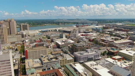 a still drone shot of the central business district of new orleans, louisiana, including the central city connection bridge, buildings, and algiers point across the mississippi river