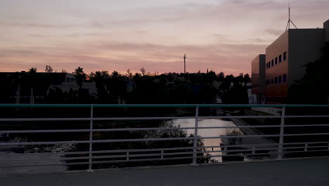 silhouette of male athlete in sportswear running and exercising in a city park at dusk