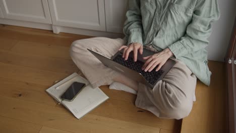 mujer trabajando desde casa en una computadora portátil