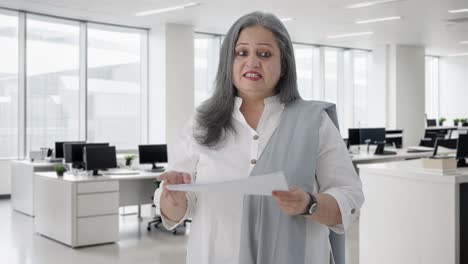 Happy-Indian-senior-female-manager-talking-in-a-meeting